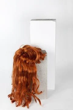 Red long wig cinder block Stock Photos