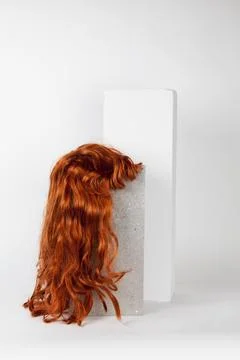 Red long wig cinder block Stock Photos