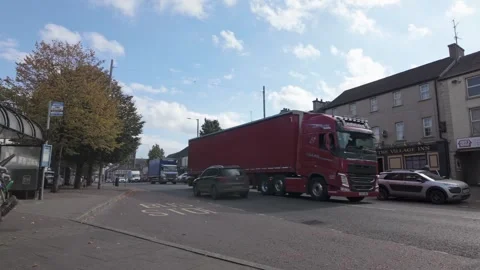Red Lorry and Traffic Passing Through Portglenone Town Centre 動画素材 317701531