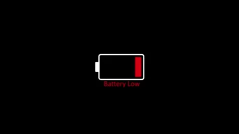 Red low battery status alert indicator icon on black background 4k video Stock Footage 345603513