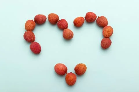 Red lychee heart shape on blue White Background.Valentines Day symbol Made of Stock Photos