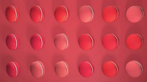 Red macaron pastries photographed on light paper background. Pattern with rotati Video stock 154929663