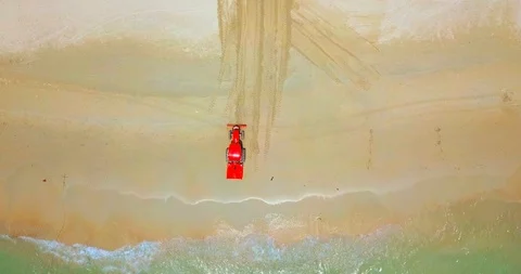 Red machine cleaning a sand beach Stock Footage 88682610