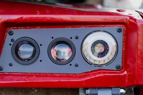Red machine panel with optical lenses and LED lighting system Stock Photos