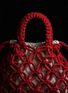 Red Macrame Handbag with Fabric Inner Bag on Black Background Foto stock