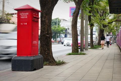 Red mailbox on the side walk. Stock Photos