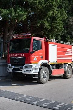 Red MAN fire engine is parked on an asphalt road in Montenegro Foto stock