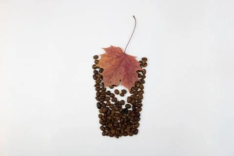 Red maple leaf in bean seeds arranged in the shape of a glass Stock Photos