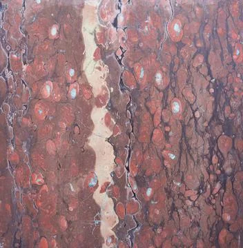 Red marble with large white flecks and vertical veins Stock Photos
