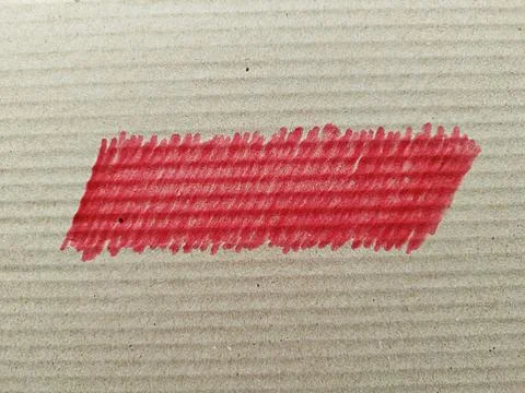 Red marker scribble on the surface of a gray box Stock Photos