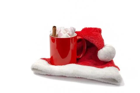 Red marshmello cup, red hat, christmas lollipop, cinnamon stick and fir twigs Stock Photos