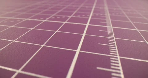 Red mat for macro cutting paper and fabric on desk Stock Footage 248312829