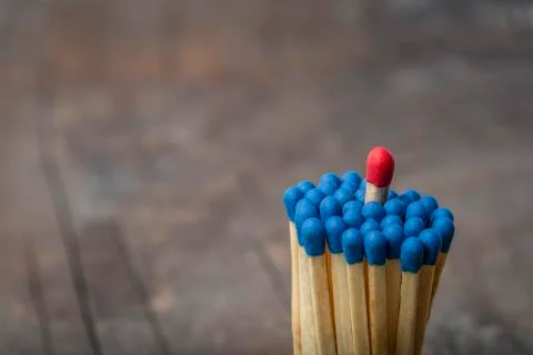 Red Match in group of blue matches Stock Photos