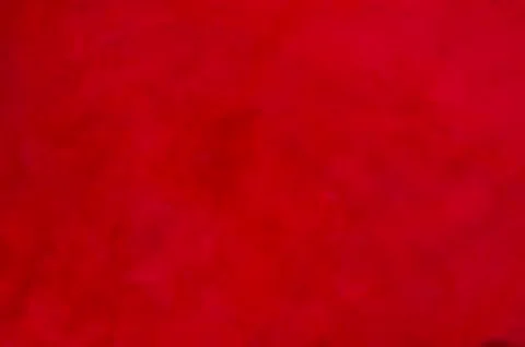 Red matte background of suede fabric, closeup. Velvet texture of seamless win Stockfoto's