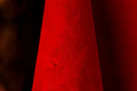 Red matte background of suede fabric, closeup. Velvet texture of seamless lea Stock Photos