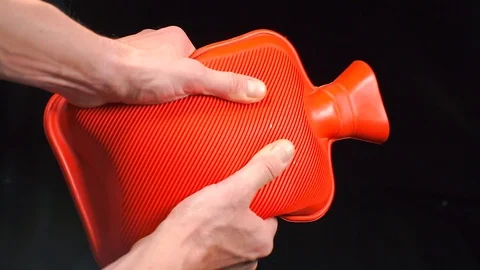 Red medical hot-water bottle in the doctors hands. Stock-Footage 119443653