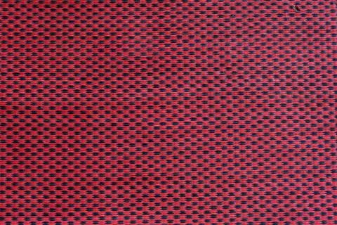 Red mesh fabric, close-up, background, texture. Copy space, horizontal. Stock Photos