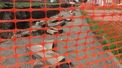 Red mesh fence danger. Open trench with pipes of the heating installation. Stock Footage 136818392