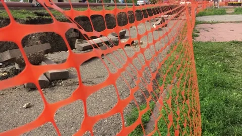 Red mesh fence danger. Open trench with pipes of the heating installation. Stock Footage 136818448