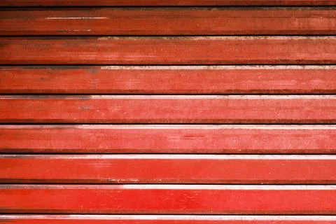 Red metal automatic garage shutter closeup, steel striped sliding door Stock Photos