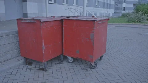 Red metal garbage containers in yard of public institution Video stock 253334321