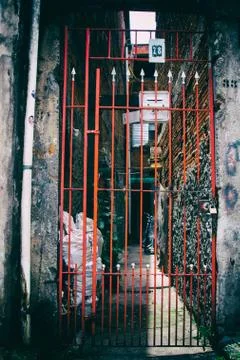 Red metal gate of a favela in Brazil. Stock Photos