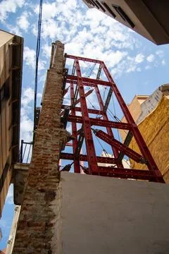 Red metal structure in urban setting Stock Photos
