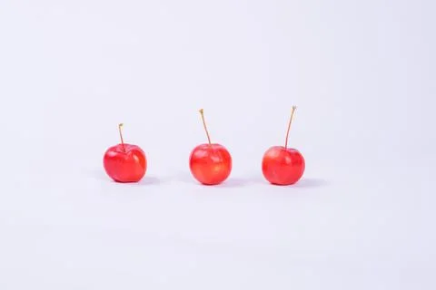Red mini-apples on a light background Stock Photos