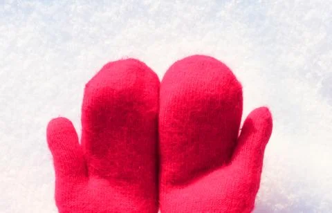 Red mittens lie on the snow. mitten lying on the snow in winter. Holiday Stock Photos
