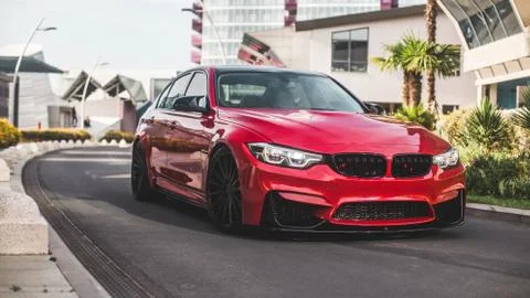 Red model sedan on the empty city roads 写真素材