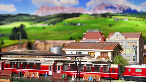 Red model toy train in miniature arrive to the station. Stock Footage 228217546