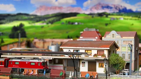 Red model toy train in miniature arrive to the station. Stock Footage 228220162