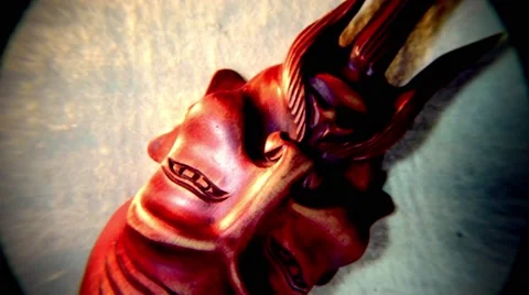 Red Mongolian Mask Spinning in a Circle Top View Close-Up Stock Footage 62635613