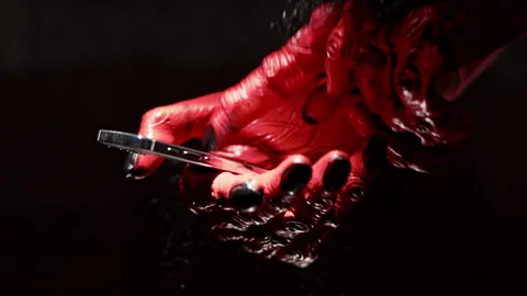 Red Monster Fingers Using Smartphone Close-Up Stock Footage 318982743