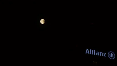 Red moon eclipse and Allianz Building Milan Italy detail Stock-Footage 151844514