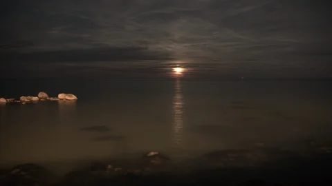 Red moon rising from the sea Time lapse, Ungraded UHD Stock Footage