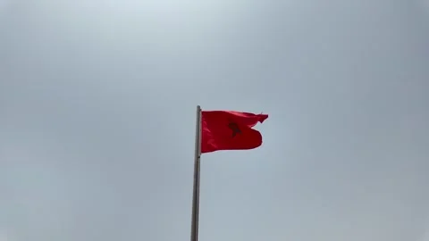 Red Morocco flag is waving at a beautiful and peaceful blue sky in Agadir Stock Footage 280197864