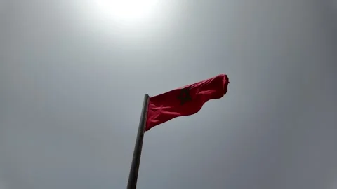 Red Morocco flag is waving at a beautiful and peaceful blue sky in Agadir 動画素材 280197875