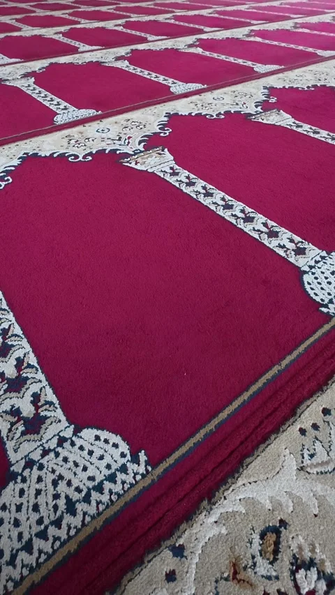 Red mosque prayer carpet arranged in ornate repeating rows Stock-Footage 342589635