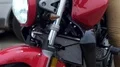 Red motorbike with turned on headlight, motocross in rain, race in countryside HD Footage