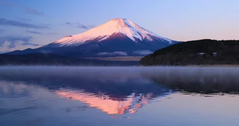 Red Mount Fuji reflecting on Lake Yamanaka with morning mist Stock Footage 337451265