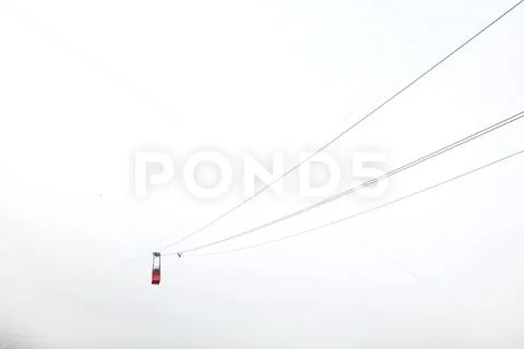 Red mountain cableway car in clouds and fog Stock Photos