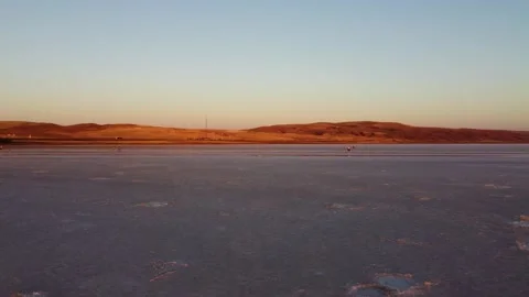 Red mountains on sunset behind salt lake Tuz in Turkey Stock-Footage 169477007