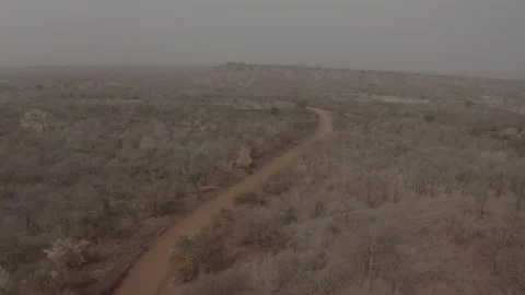 Red mud road from Senegal, in the Tambacounda region. West Africa. DLOG Stock Footage