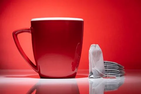 Red mug and a tea bags on the red background Stock Photos
