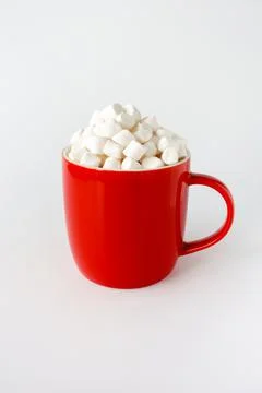 Red Mug filled with Mini Marshmallows isolated on White Stock Photos