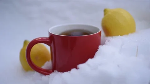 Red mug of steaming hot tea Buried in  snow. Stock Footage 119081109