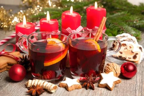 Red mulled wine on table with burning candles Stock Photos