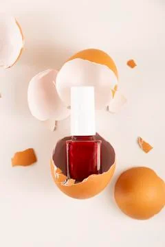 Red nail polish in eggshell on light background Stock Photos