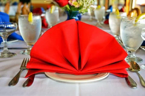Red napkin on dinner table Stock Photos